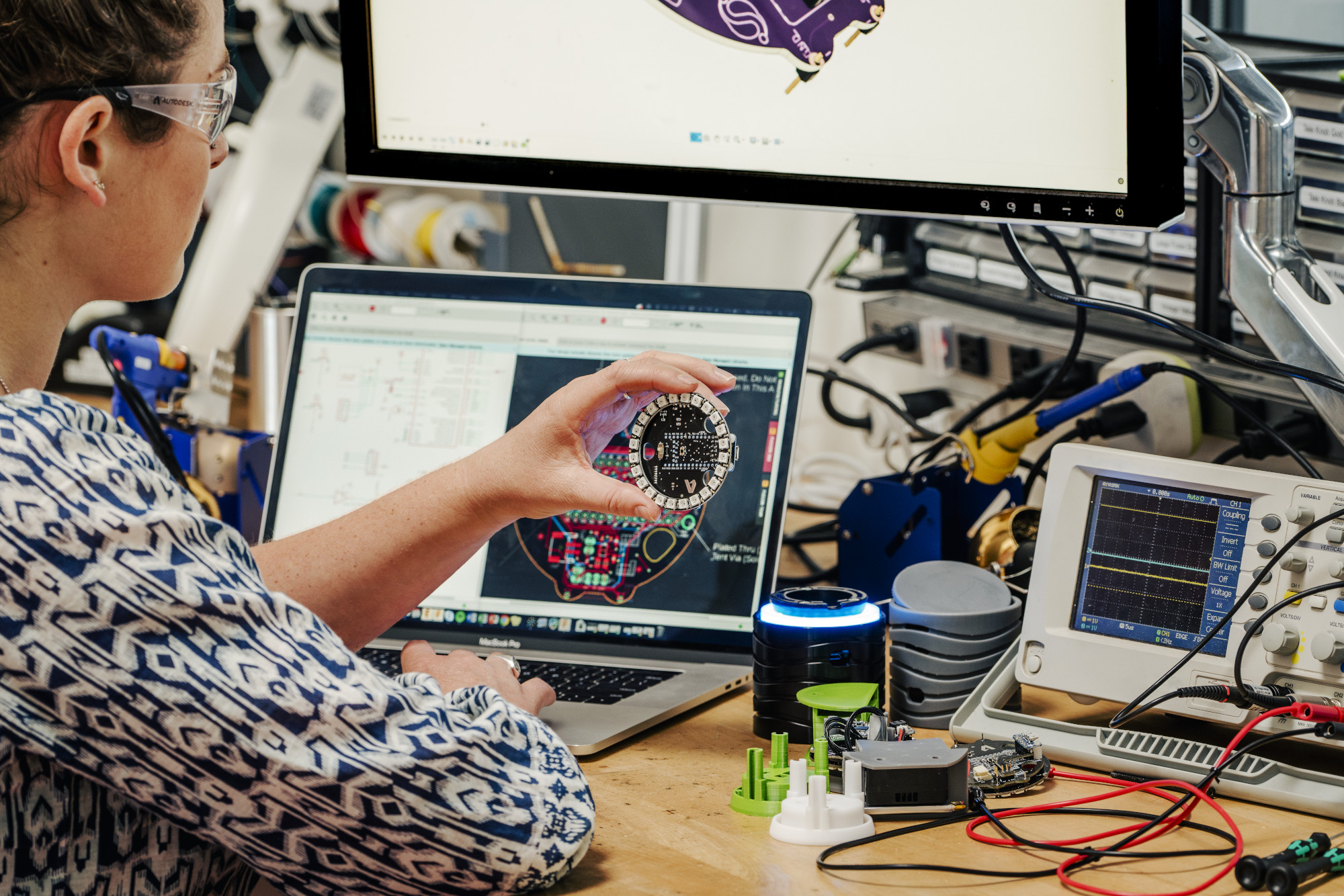 Woman working in the electrical workshop at the Autodesk San Francisco Technology Center using Fusion 360.