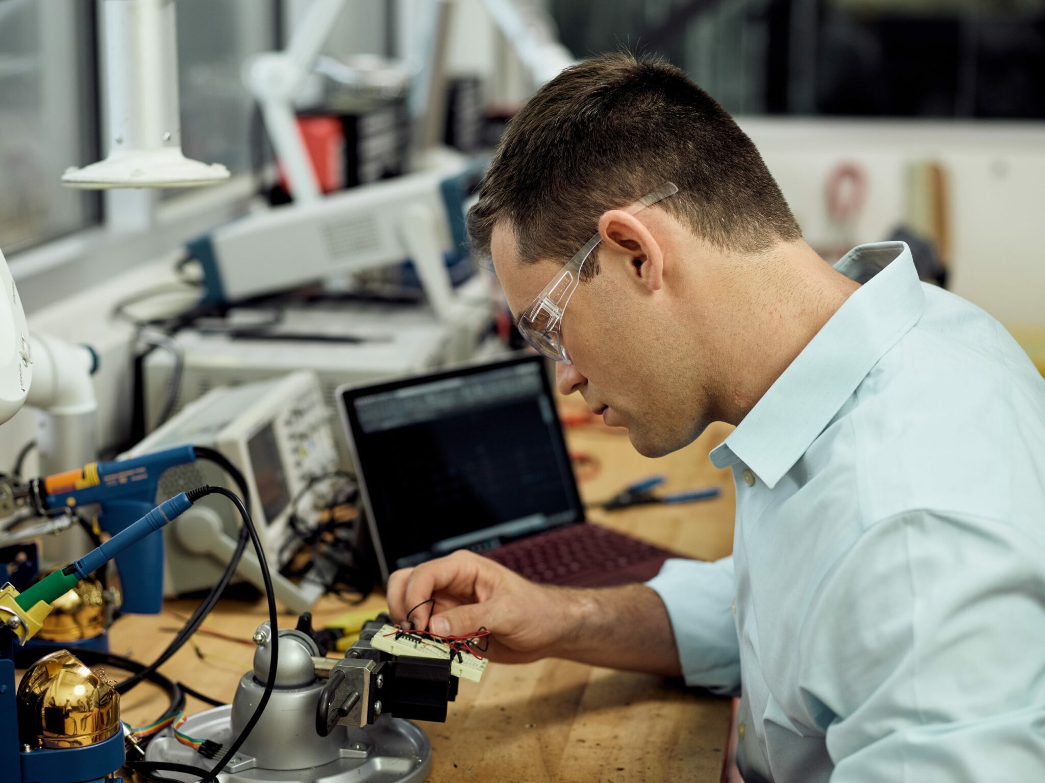 Man working with AutoCAD verticals in the electrical workshop at Pier 9, San Francisco, CA.